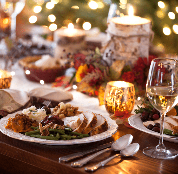 Thanksgiving holiday meal set on table with lights in background
