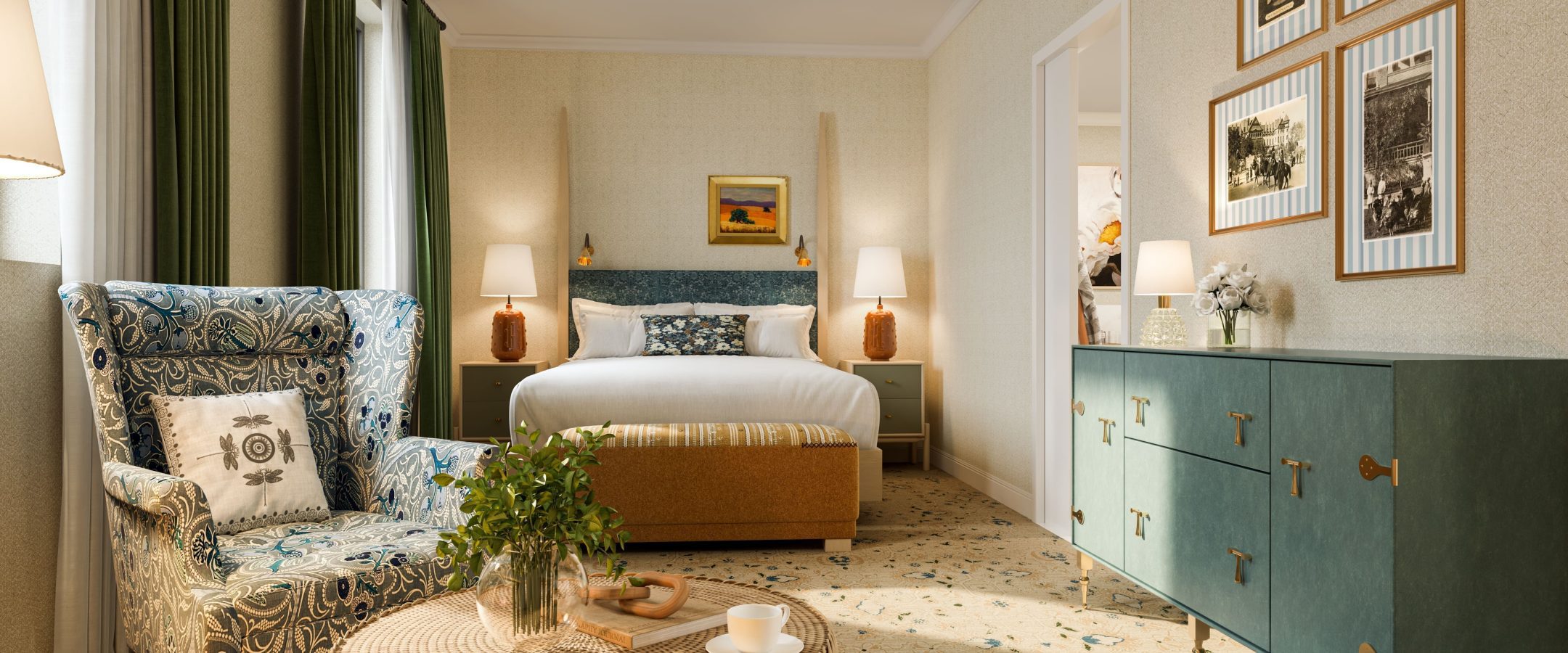 A cozy, well-lit hotel room features a double bed with a green headboard, a patterned armchair, a wicker table with a plant and cup, framed art on the walls, and a green dresser with decor.
