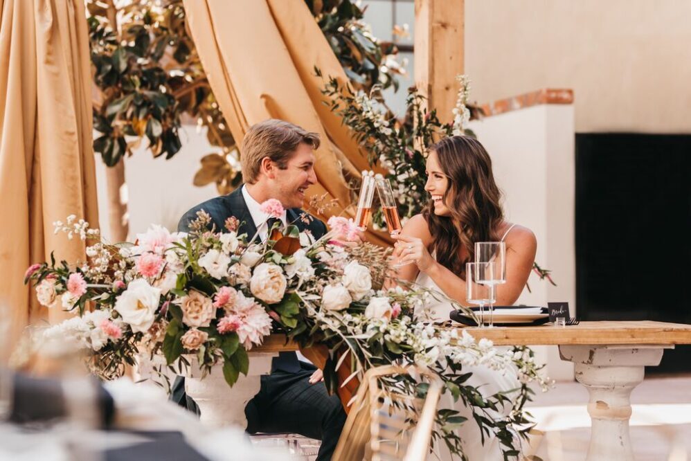 Bride and Groom cheers with champagne