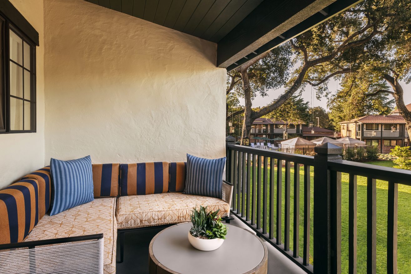 Garden Studio balcony looking out into the garden with a round table a large potted succulent at Paso Robles Inn.