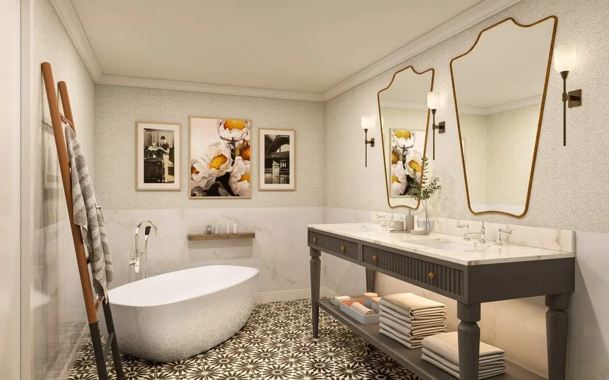 Modern hotel bathroom with elegant fixtures, featuring a spacious vanity, large mirror, glass-enclosed shower, and neutral tones for a clean, sophisticated look.